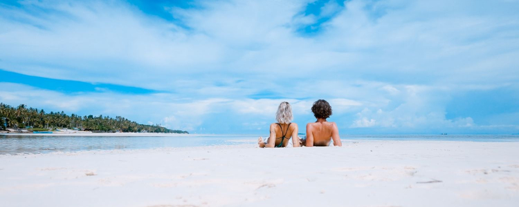 couple lazes on the beach during summer