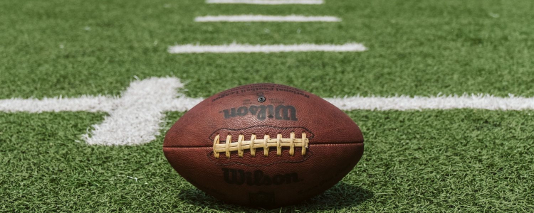 football sits on green turf