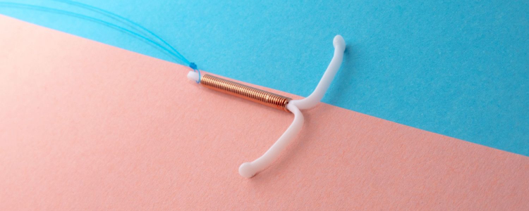 IUD against a blue and pink background