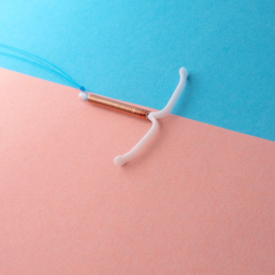 IUD against a blue and pink background