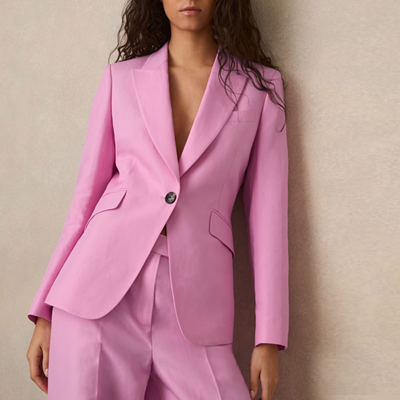 executive wears pale pink suit