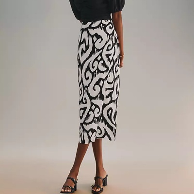 A woman wearing a black and white printed pencil skirt with black sandals