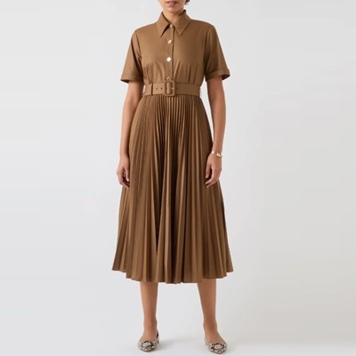 A woman wearing a brown shirtdress and croc-print flats