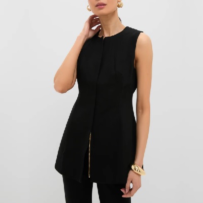A woman wearing a black sleeveless top