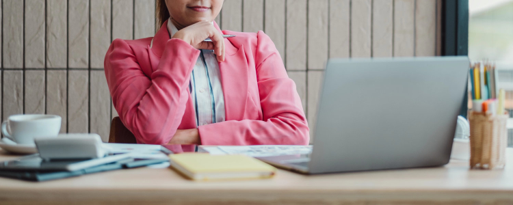 woman wearing a pink blazer at the office