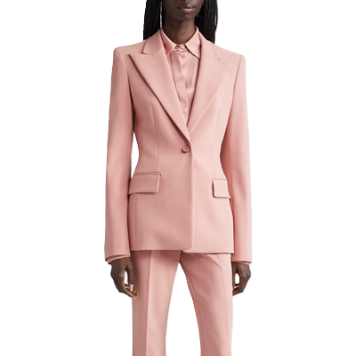 Black executive wears pale pink rose suit