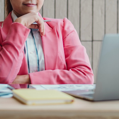 woman wearing a pink blazer at the office