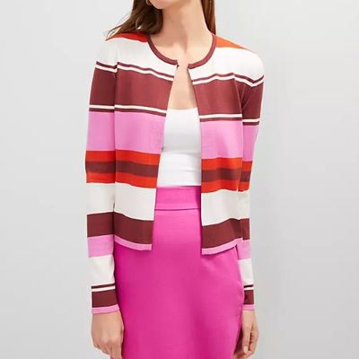 A woman wearing a colorful stripe open cardigan and pink skirt