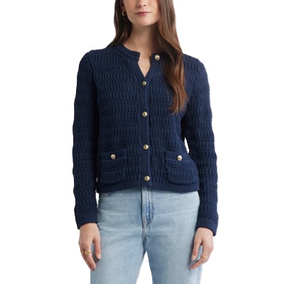 A woman wearing a navy sweater and light blue jeans