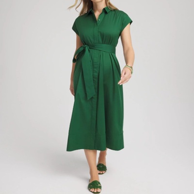 A woman wearing a emerald green dress and green sandals