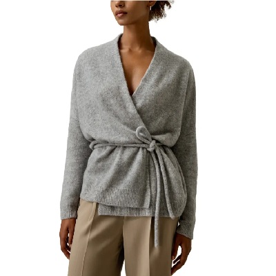 A woman wearing a gray wool knit cardigan and khaki-colored pants