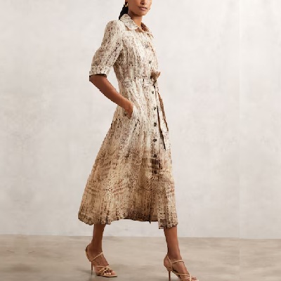 A woman wearing a animal print short sleeve dress with nude heels