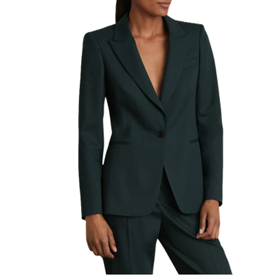 woman wears dark green suit