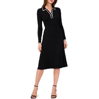 A woman wearing a black long sleeve sweater dress with black heels