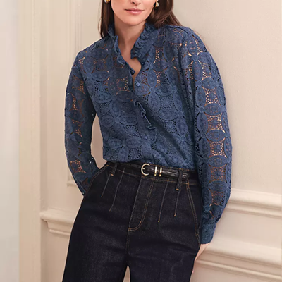 woman wears dark blue lacy blouse that's slightly sheer