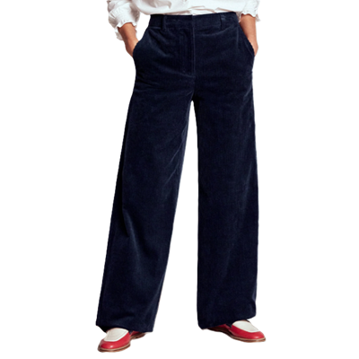 woman wears wide leg corduroy pants with white and red loafers