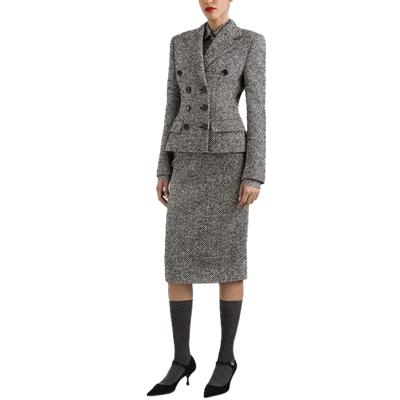 example of how NOT to wear a suit: woman wears a conservative gray skirt suit with knee-high socks and Mary Jane heels