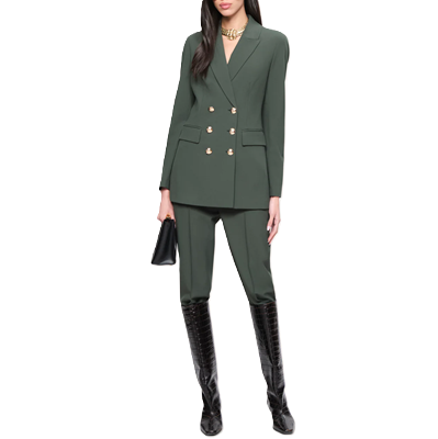 example of how NOT to wear a suit: woman wears a dark green suit with her pants tucked into knee-high boots