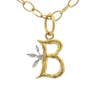 gold pendant reads "B" with a branched diamond part coming out before the middle of the B