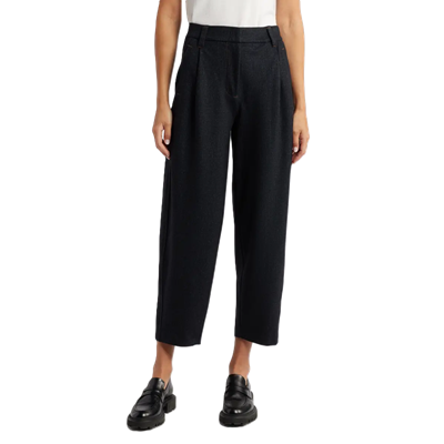 woman wears black barrel pants with loafers