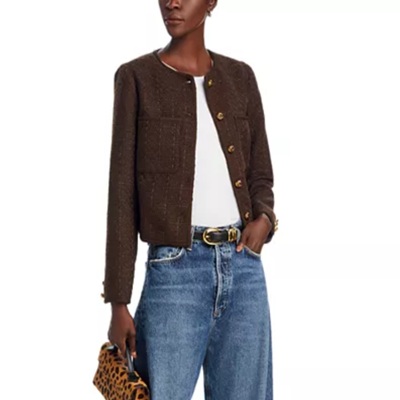 A woman wearing a white top and brown tweed jacket with denim pants with leopard small bag and black belt