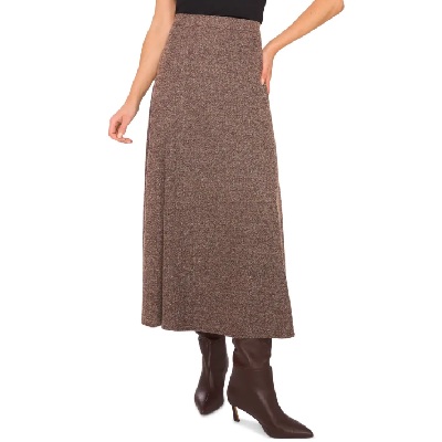 A woman wearing a brown tweed maxi skirt with a pair of brown pointed boots