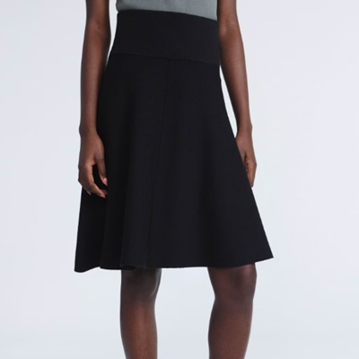 A woman wearing a black high waist skirt