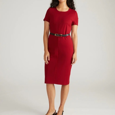 A woman wearing a red dress with black belt
