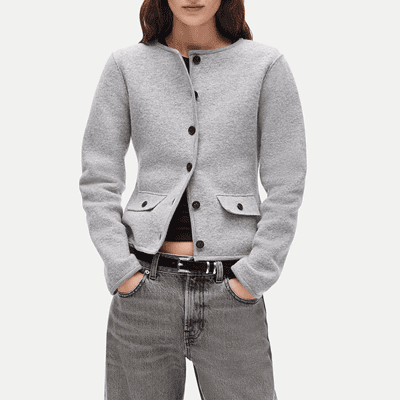 woman wears gray buttoned sweater blazer