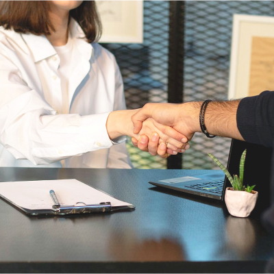 woman shakes hands with interviewer, it's her turn to interview for better career opportunities
