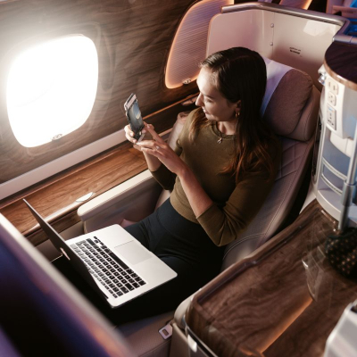 businesswoman looks our airplane window; she is wondering what the most versatile business travel clothes are