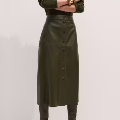 A woman wearing green leather maxi skirt