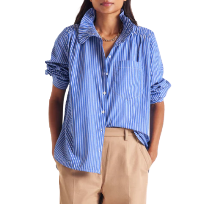 professional woman wears blue blouse with interesting collar