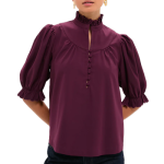 professional woman wears deep purple blouse with interesting collar