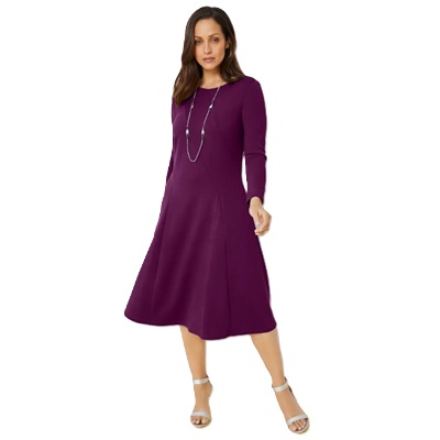 A woman wearing a purple dress, necklace, and silver high-heel sandals