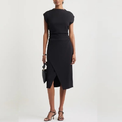 A woman wearing a black midi dress with black bag and sandals