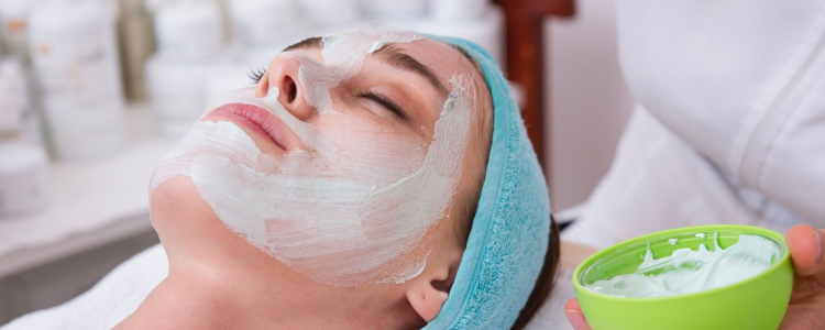 woman relaxes while getting a facial