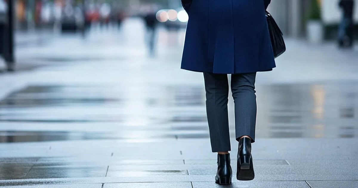 professional woman walking along city street wearing the best ankle boots for work