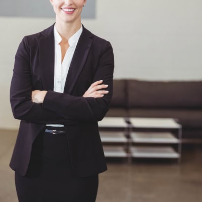 stylish, confident businesswoman who just might be petite wears a flattering petite suit for women