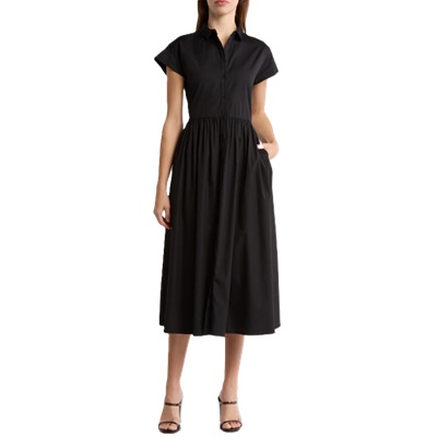 A woman wearing a black midi dress and black strappy heels