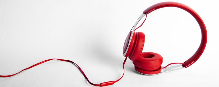 red headphones laid across white table