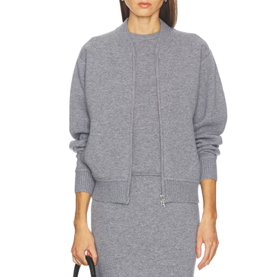 woman wears gray knit bomber jacket, gray tank, and matching gray knit skirt