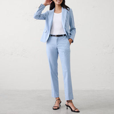woman wears light blue suit with straight leg pants and shrunken jacket