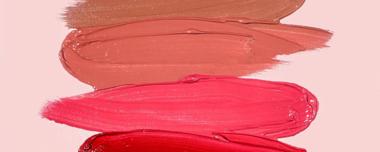 smears of colorful lipstick against a pink background