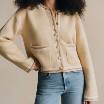 professional young woman wears a deep burgundy short-sleeve knit top with a crew neckline and ribbed hem
