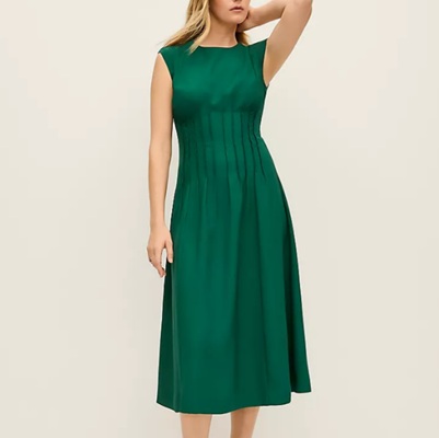 A woman wearing a green sleeveless midi dress