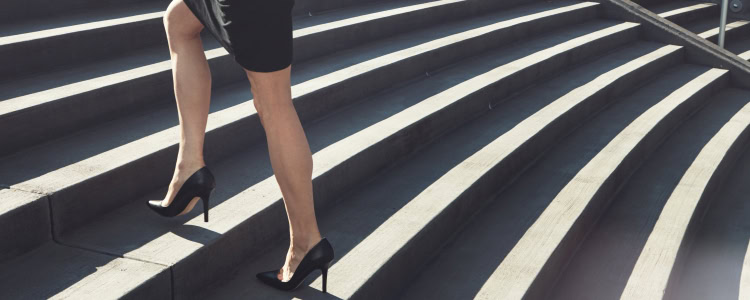 stylish businesswoman climbing stairs