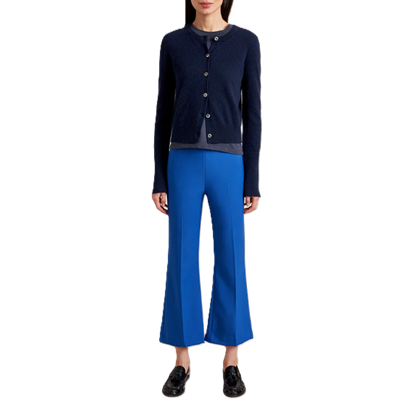 Woman wears colorful pants with two neutrals: cobalt pants, black sweater, gray t-shirt