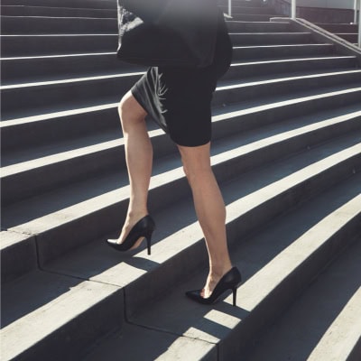 stylish businesswoman climbing stairs