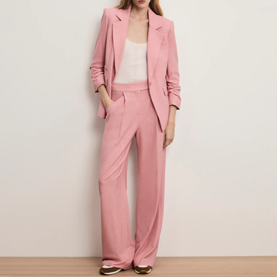 woman wears pale dusty pink pantsuit